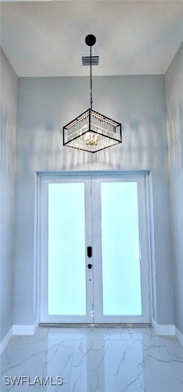 interior details featuring a notable chandelier