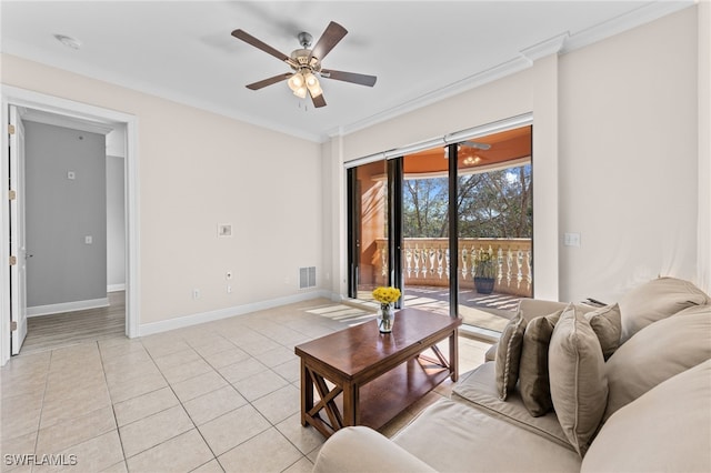 tiled living room with ceiling fan and ornamental molding