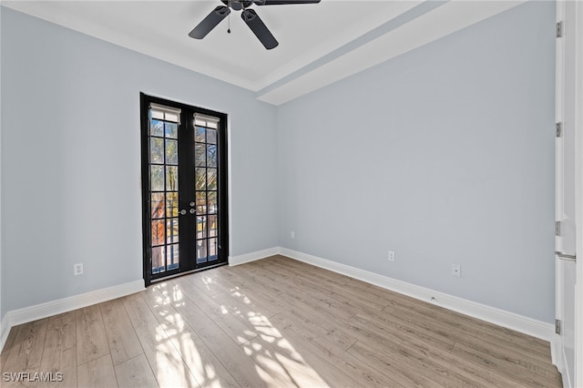 spare room with ceiling fan, light wood-type flooring, and french doors