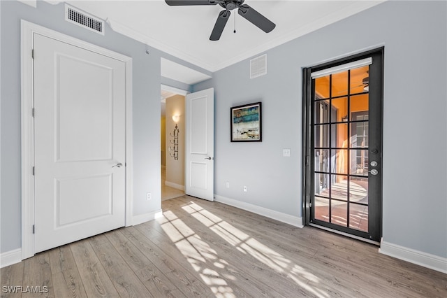 unfurnished room featuring ceiling fan, ornamental molding, and light wood-type flooring