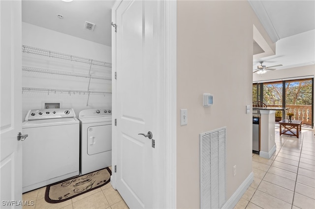 laundry area featuring ceiling fan, light tile patterned floors, and independent washer and dryer