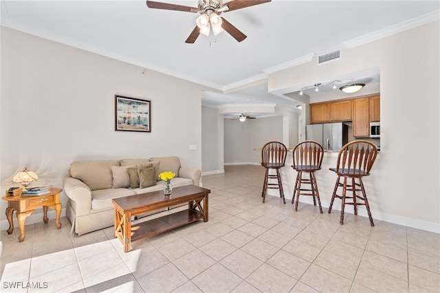 living room featuring ornamental molding, light tile patterned flooring, and ceiling fan