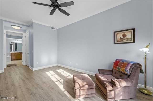 sitting room with ceiling fan, light hardwood / wood-style flooring, and crown molding