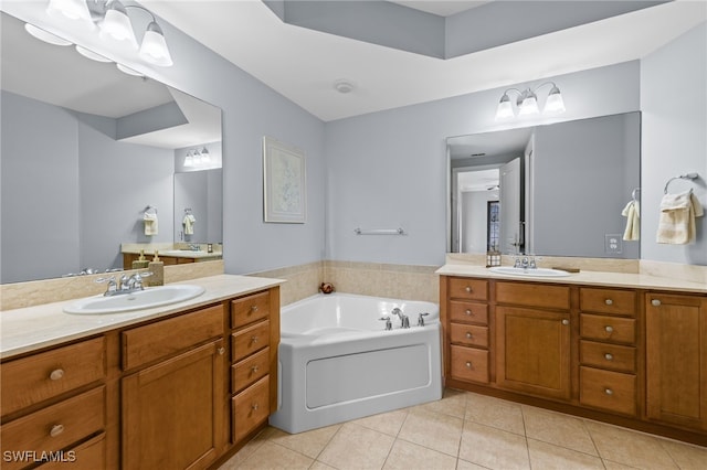 full bath featuring two vanities, a sink, tile patterned flooring, and a garden tub