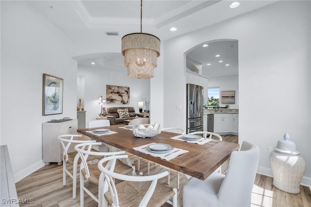 dining area featuring a chandelier and light hardwood / wood-style flooring