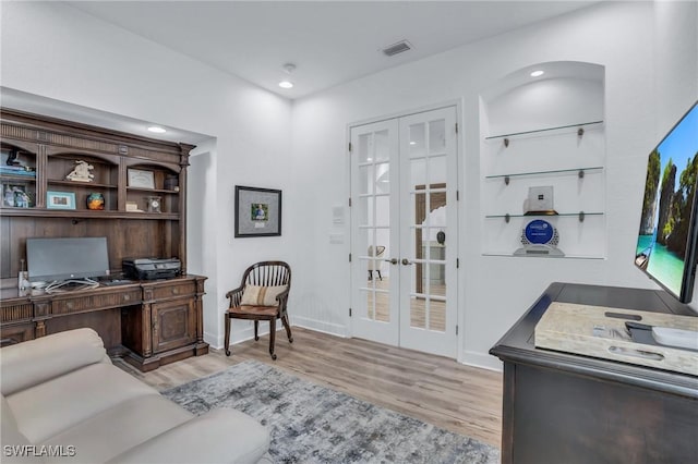 office featuring light hardwood / wood-style floors and french doors