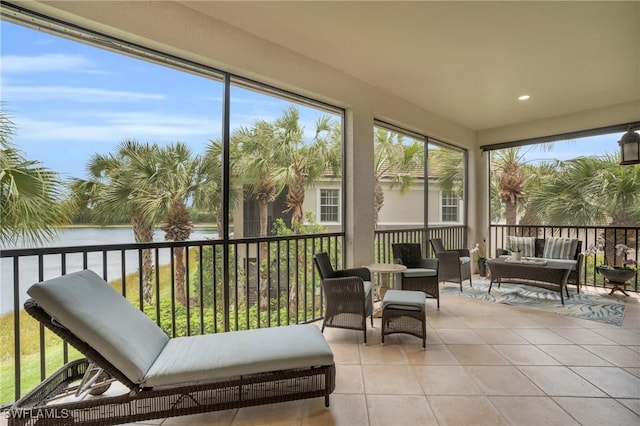 sunroom / solarium featuring a water view