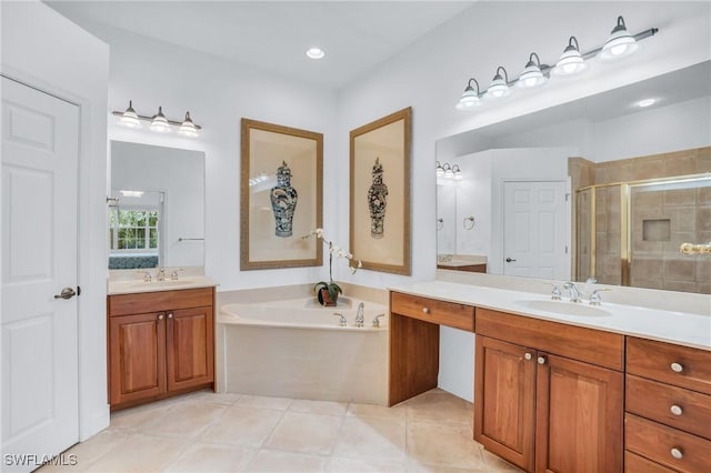 bathroom with tile patterned flooring, vanity, and shower with separate bathtub