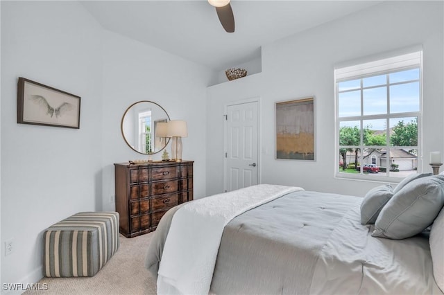 bedroom with ceiling fan and light carpet