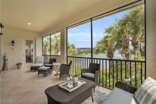 sunroom / solarium featuring a water view