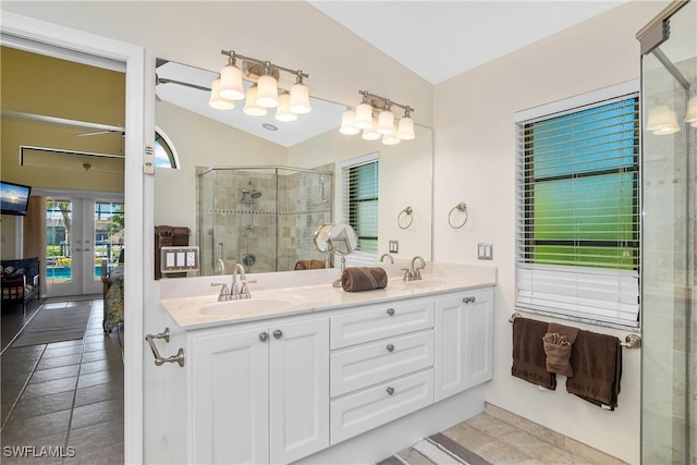 bathroom featuring vanity, french doors, tile patterned floors, vaulted ceiling, and an enclosed shower