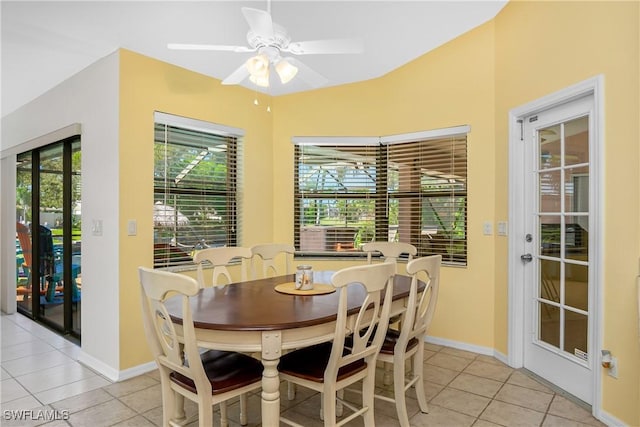 tiled dining room featuring ceiling fan