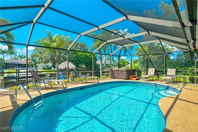 view of swimming pool featuring a hot tub, a lanai, and a patio area