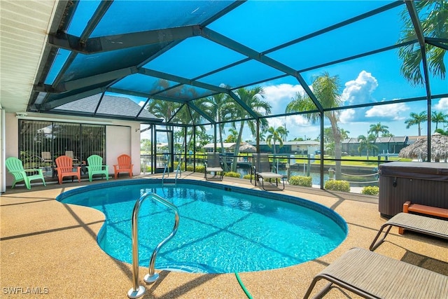 view of swimming pool with a lanai, a patio area, a water view, and a hot tub