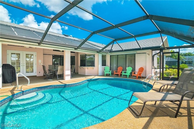 view of swimming pool featuring french doors, area for grilling, glass enclosure, and a patio area