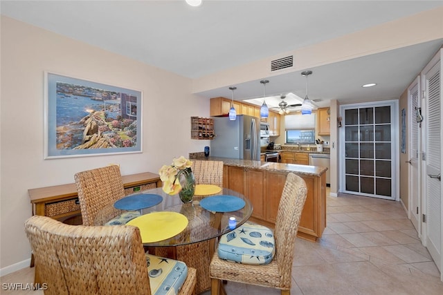 dining area with sink and light tile patterned floors