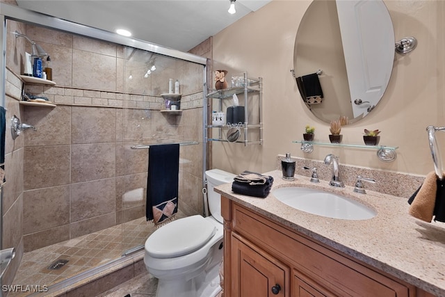 bathroom with walk in shower, vanity, and toilet