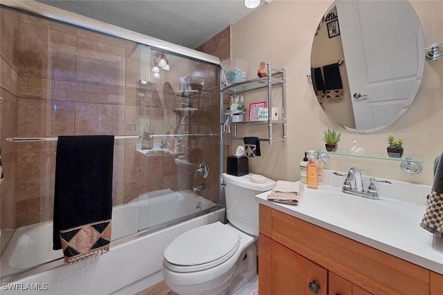 full bathroom featuring toilet, vanity, and bath / shower combo with glass door