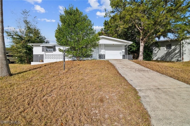 ranch-style home featuring a front yard and a garage