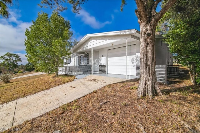 single story home with covered porch and a garage