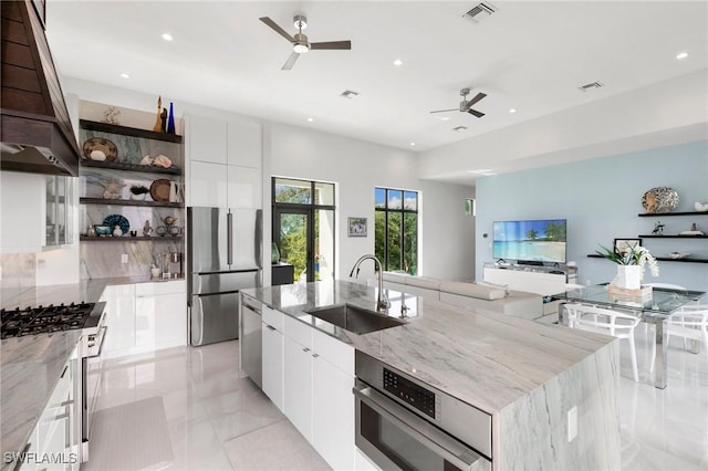 kitchen featuring open shelves, modern cabinets, appliances with stainless steel finishes, and a sink