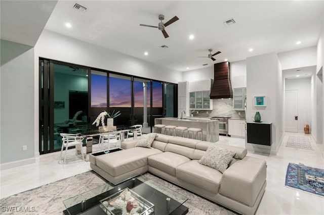 living area with baseboards, recessed lighting, visible vents, and ceiling fan