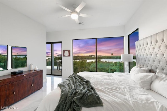 bedroom with visible vents, a water view, access to exterior, and a ceiling fan