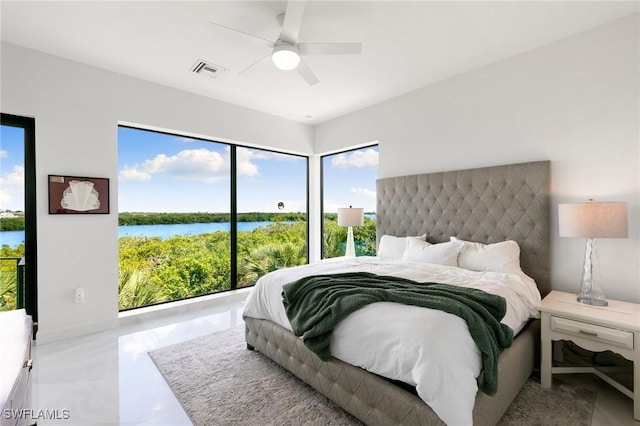 tiled bedroom featuring visible vents, a water view, and ceiling fan