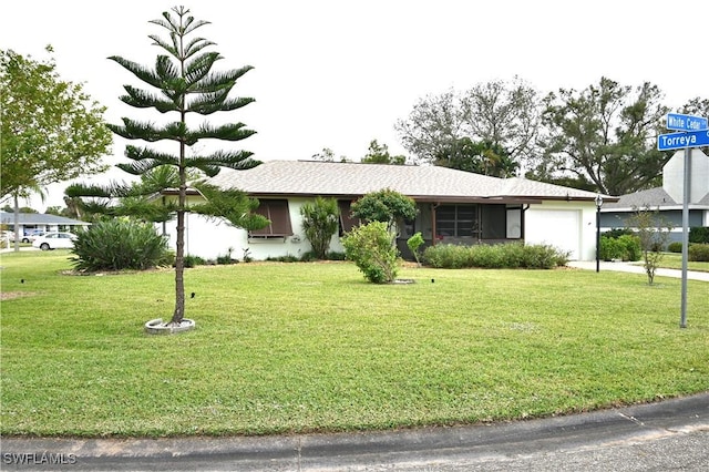 single story home with a front yard and a garage