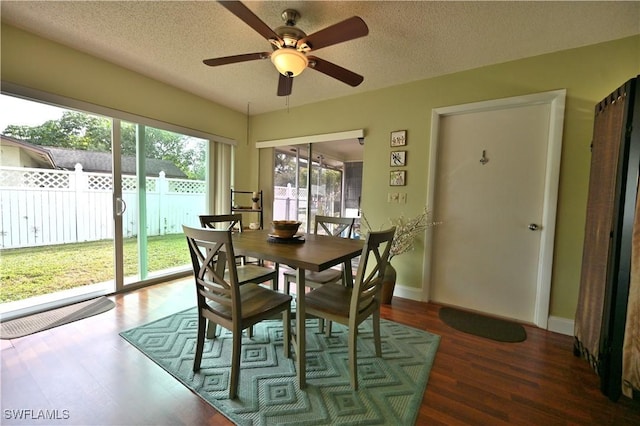 dining space with a textured ceiling, dark hardwood / wood-style floors, and ceiling fan