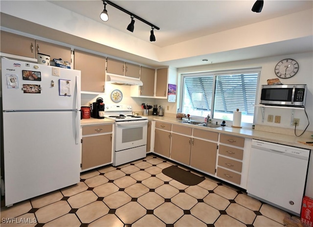 kitchen with sink, track lighting, and white appliances