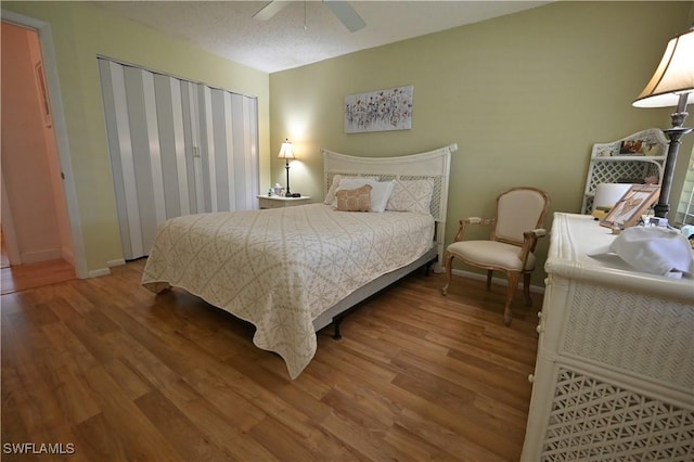 bedroom with ceiling fan and wood-type flooring