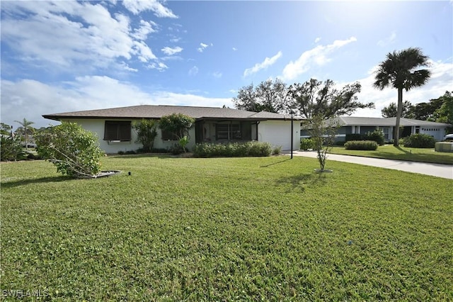 ranch-style home featuring a front lawn and a garage