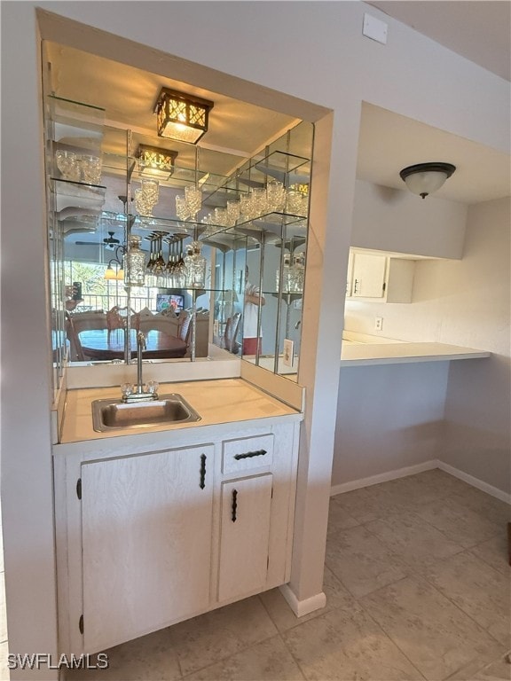 bar with sink and light tile patterned floors