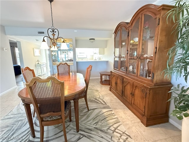 tiled dining area with a notable chandelier