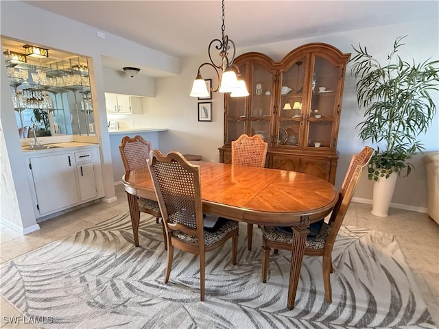 dining area featuring sink, light tile patterned floors, and a chandelier