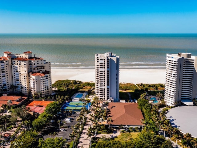 drone / aerial view featuring a beach view and a water view