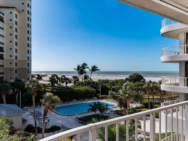 view of pool featuring a view of the beach and a water view