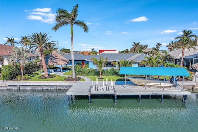 dock area with a water view and a yard