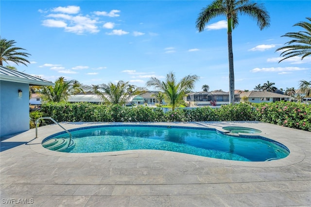 view of pool featuring an in ground hot tub and a patio