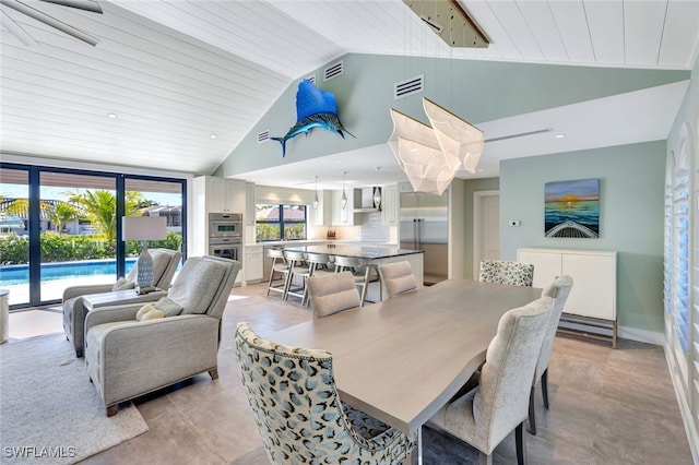 dining space featuring wooden ceiling and high vaulted ceiling