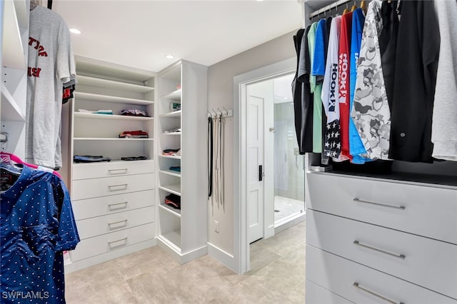 spacious closet with light tile patterned floors