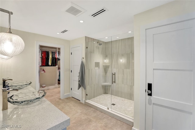 bathroom with tile patterned floors and a shower with shower door