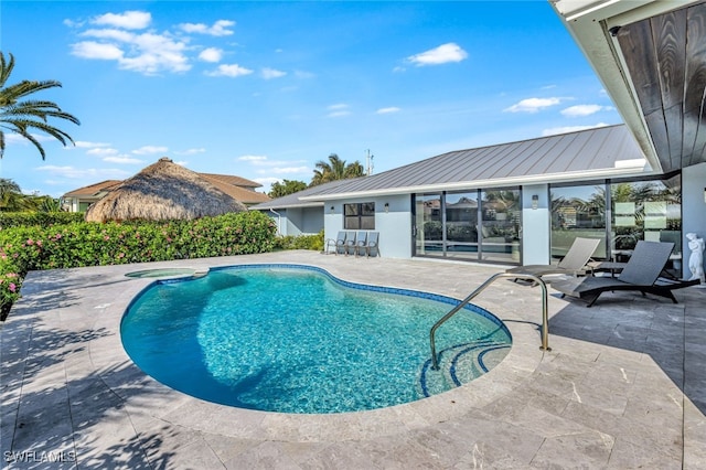 view of pool with an in ground hot tub and a patio area