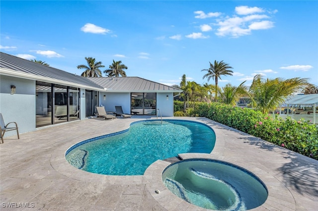 view of swimming pool with an in ground hot tub and a patio