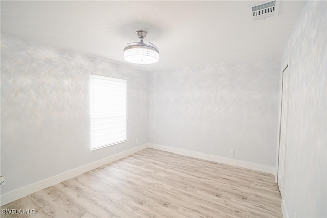 spare room with light hardwood / wood-style flooring