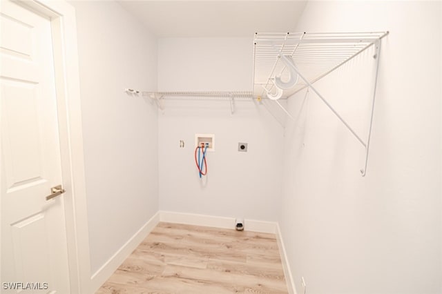 laundry area with hookup for an electric dryer, washer hookup, and light hardwood / wood-style floors