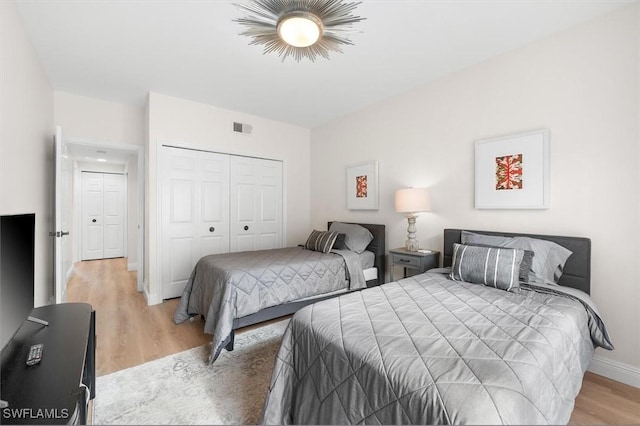 bedroom featuring a closet and light hardwood / wood-style floors