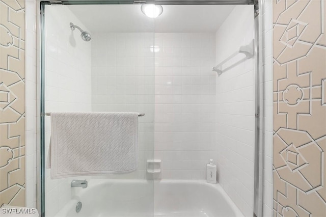 bathroom featuring bath / shower combo with glass door