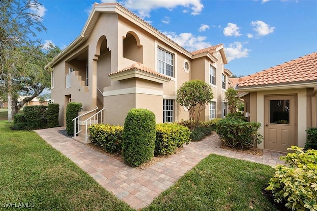 view of side of home with a yard